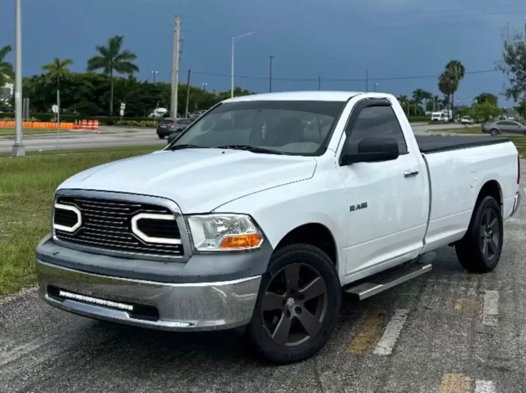 White Ram pickup truck with dark carbon window tint parked outdoors